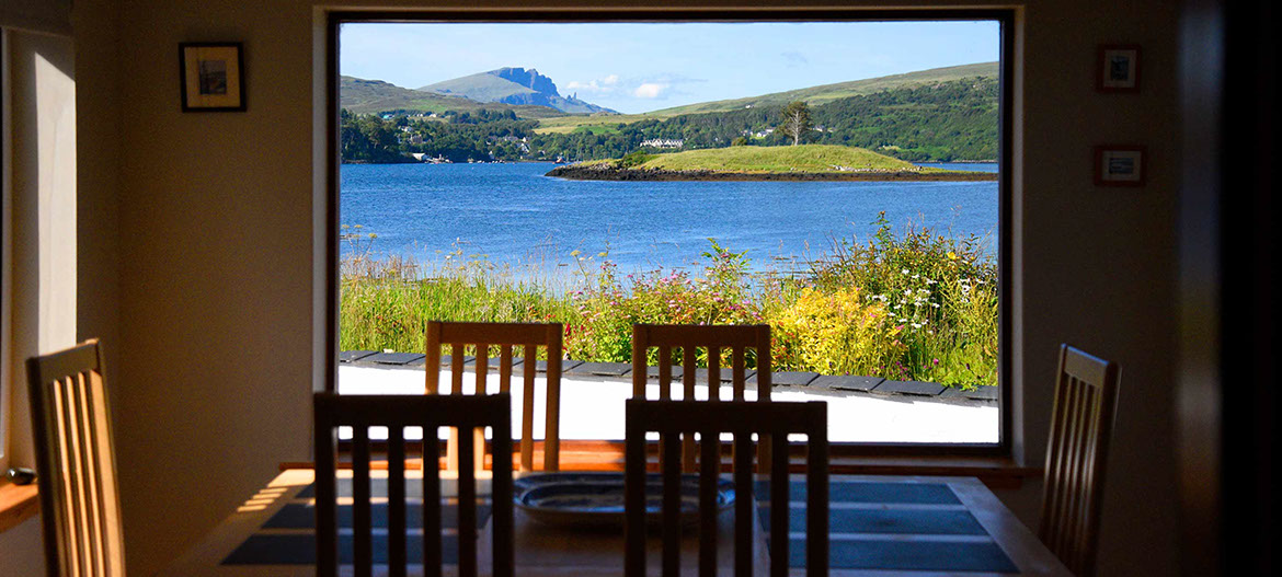 Wake up to sea and mountan views of Loch Portree when you stay at Caberfeidh Boat House self catering accommodation