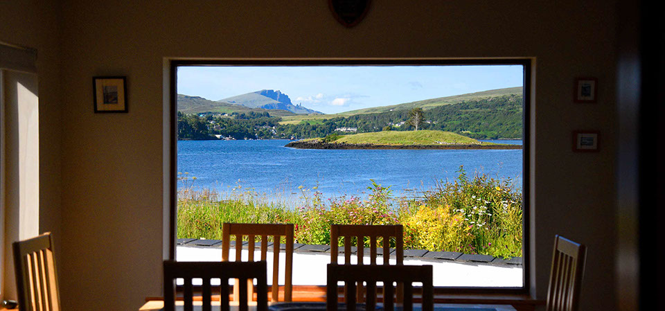 Wake up to sea and mountan views of Loch Portree when you stay at Caberfeidh Boat House self catering accommodation